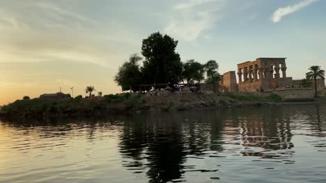 Most-Beautiful-Philae-temple-at-sunset-light-the-beautiful-temple-of-Philae-and-the-Greco-Roman-buildings-are-seen-from-the-Nile-river-a-temple-dedicated-to-Isis,-goddess-of-love-Aswan-Egyptian