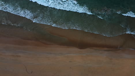 Overhead-Shot-Of-Smooth-Wave-Fading-On-Tropical-Beach