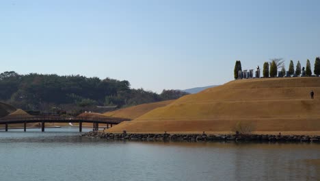 Man-made-Lake-Garden-with-Bonghwa-Hill-and-Bridge-of-Dreams-in-Suncheon-Bay-National-Park-over-clear-sky---copy-space-landscape
