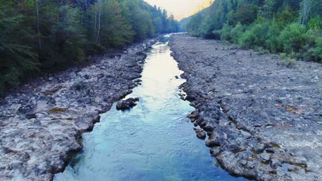 Slow-motion-aerial-flying-over-Kolpa-river,-a-natural-border-dividing-Croatia-and-Slovenia