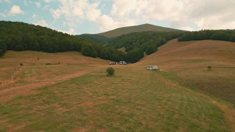 Camper-Vans-With-Tourist-Parked-On-The-Plains-Down-The-Hills-And-Valley-In-Umbria,-Italy
