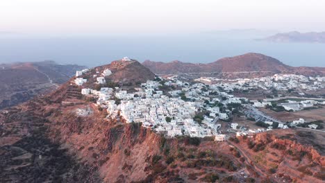 Plaka-village-town-in-Milos-island-at-the-top-of-a-hill,-aerial-greek-landscape