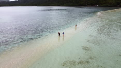 Orbit-Shot-Over-Tourists-Enjoying-Clear-Island-Water-On-Marvelous-Sand-Bar
