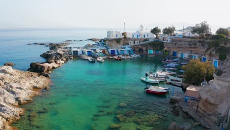 Mandrakia-small-fishing-village-port-with-boats-Slow-Drone-Shot-Calm-Morning-Milos-Island,-Greece