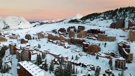 Aerial:-beautiful-Avoriaz-ski-resort-in-French-Alps,-winter-panoramic-at-sunset