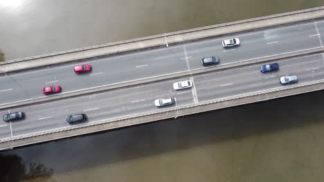 Aerial-view-of-traffic-crossing-a-river-on-a-bridge