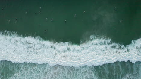 Aerial:-Llandudno-big-wave-surfers-sunset