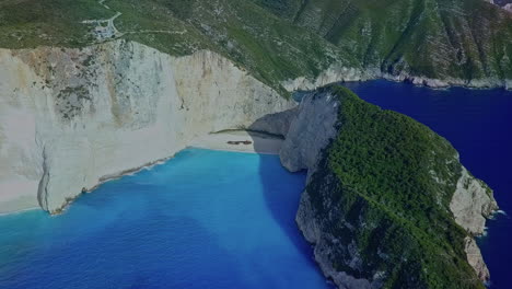 Wide-aerial-orbiting-Navagio-Shipwreck-beach-on-Zakynthos-Greece-island