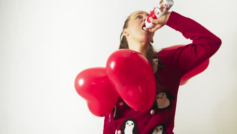 Woman-with-red-hearts-around-her-neck-fills-her-mouth-with-whipped-cream-spray
