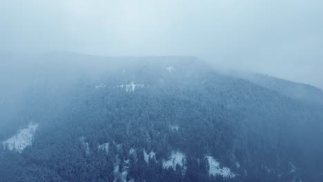 Winter-mountain-aerial-view-of-dark-forest-covered-snow-in-Vosges-France-4K
