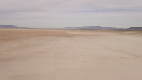 Global-warming-parched-earth-drought-landscape-in-Arizona-on-a-dry-lake-bed,-aerial-panning-shot