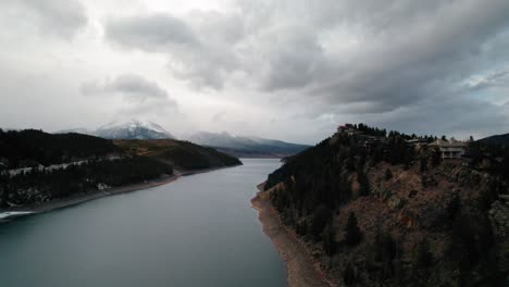 Cloudy-Moody-Drone-Aerial-View-Of-Hilltop-House-Near-Snake-River-Arm-Near-Sapphire-Point-Dillon-Reservoir-Colorado