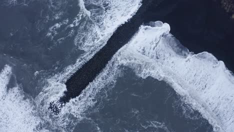 Aufsteigende-Drohne-Von-Oben-Nach-Unten-Von-Extremen-Ozeanwellen,-Die-Basaltfelsen-Und-Schwarzen-Strand-In-Island-überfluten