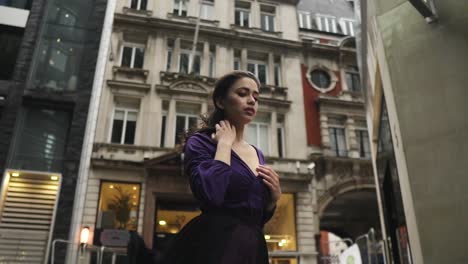 Young-female-in-purple-dress-is-touching-her-body-while-the-wind-blow-moving-her-hair-and-clothing-very-attractive-slowmotion