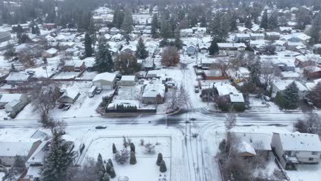 Side-scrolling-aerial-of-suburban-neighborhoods-covered-in-a-blanket-of-snow