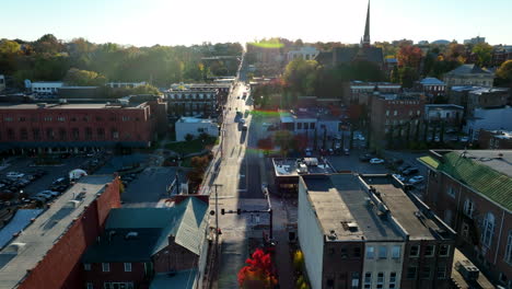 Rising-aerial-establishing-shot-of-town-in-USA-during-golden-hour-light