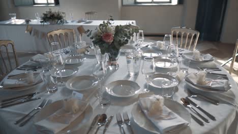 Round-table-set-with-beautiful-white-decoration,-camera-circles-around