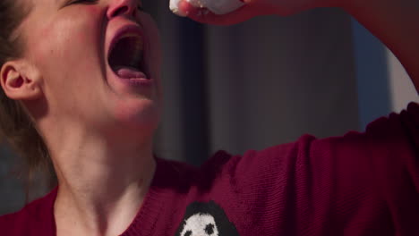 Woman-Spraying-Whipped-Cream-into-Her-Mouth
