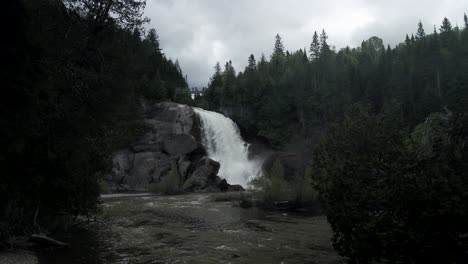 Majestic-Small-Waterfall-In-The-Center-Of-A-Forest-In-Chute-Neigette-Rimouski-Quebec---medium-shot