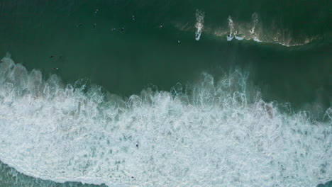 Aerial:-Surfers-trying-to-catch-a-wave-Llandudno-South-Africa