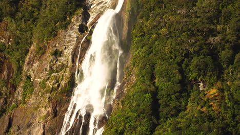 Lady-Bowen-falls-in-Milford-Sound,-static-aerial-view