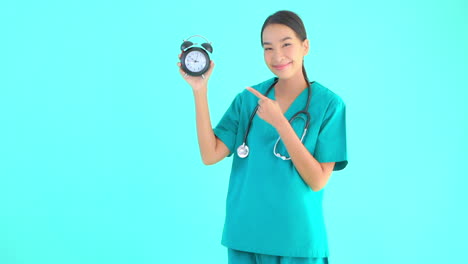 Female-Medical-Doctor-Holding-Up-Vintage-Alarm-Clock