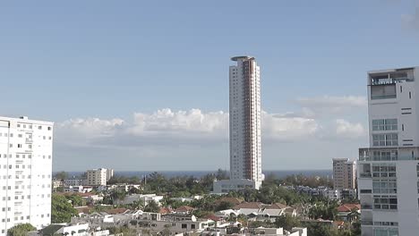 Santo-domingo,-dominican-republic---december-9,-2021---view-of-santo-domingo-city-in-the-background-Torre-Caney-Building,-Blue-Sky