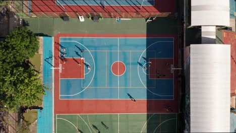 Basketball-Court-In-The-Park-With-Active-People-Playing-On-A-Sunny-Day