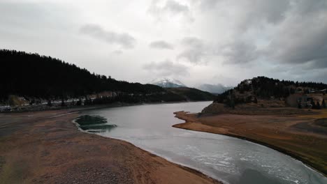 Cloudy-Moody-Drone-Aerial-View-Of-Snake-River-Arm-Water-Stream-Near-Sapphire-Point-Dillon-Reservoir-Colorado-During-Winter