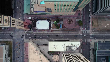 Drone-Aerial-Top-Down-View-Of-Arapahoe-Street-In-Downtown-Denver-Colorado-With-Traffic-Driving-Through-Streets-And-High-Rise-Rooftops-Around