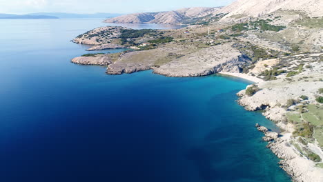 Aerial-of-deep-blue-see-surrounding-Krk-island-coastline-in-Baska,-Croatia
