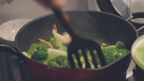 Cooking-And-Pouring-Soy-Sauce-Into-The-Stir-Fried-Brocolli-With-Prawns-On-The-Frying-Pan