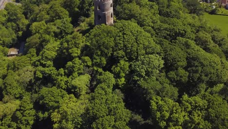 Aerial-view-of-the-Dunster-Conygar-tower-and-surrounding-areas-full-of-trees-near-Dunster-castle,-Somerset,-England