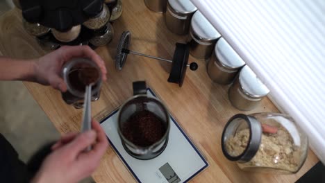 Top-down-view:-Spooning-ground-coffee-into-French-Press-on-food-scale