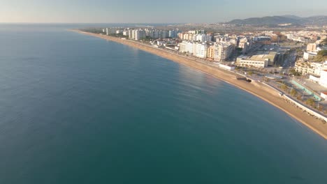 Aerial-video-of-Blanes-Girona-drone,-Mediterranean-beach-without-people-crystal-clear-turquoise-water-city-of-Costa-Brava-European-tourism