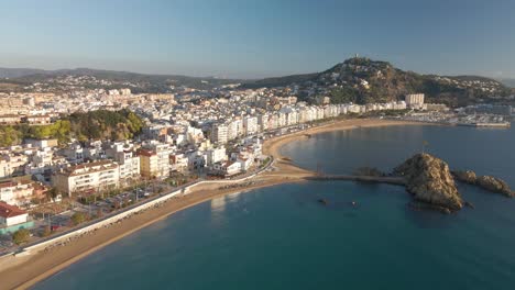 Aerial-video-of-Blanes-Girona-drone,-Mediterranean-beach-without-people-crystal-clear-turquoise-water-city-of-Costa-Brava-European-tourism