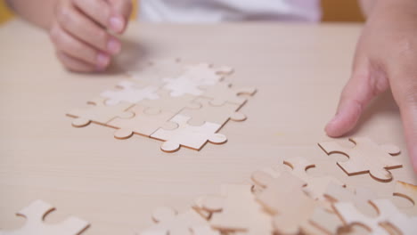 Businesswoman-hand-connecting-jigsaw-puzzle-with-sunlight-effect,-Business-solutions,-success,-and-strategy-concept