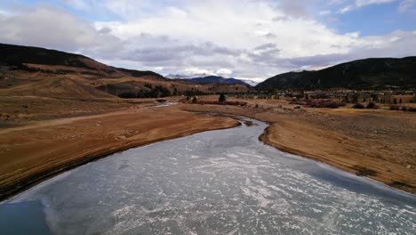 Drone-Aerial-View-Flying-Over-Small-River-Stream-With-Dry-Yellow-Riverbanks-In-Colorado-Countryside-Near-Sapphire-Point-Dillon-Reservoir