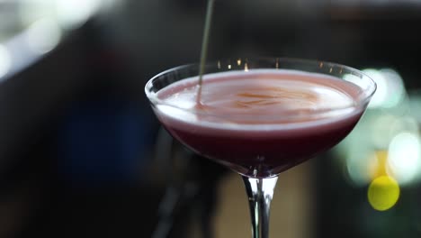 Bartender-Mixing-Ingredients-in-Fruity-Red-Cocktail-Martini,-Closeup