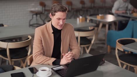guy-talking-on-laptop-in-cafe