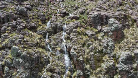 pampas-galeras-waterfall-among-rock-cliff-going-down-Apurimac,-Peru