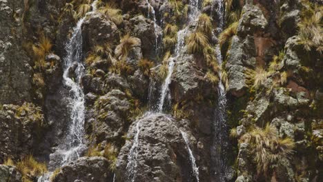 Flowing-waterfall-down-cliff,-Pampas-Galeras,-Peru
