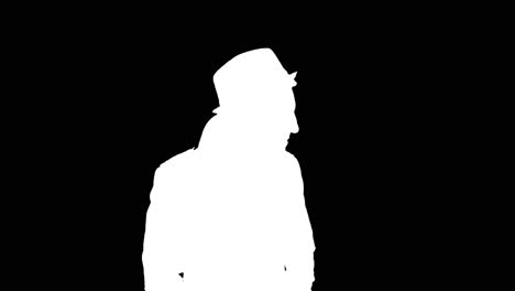 Man-in-long-coat-puts-on-hat,-white-silhouette-on-black-background