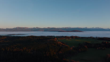 Winter-Fog-Overcast-The-Lowlands-In-Geneva-Lake-Region-With-Swiss-Alps-Visible-At-Distant-In-Vaud,-Switzerland
