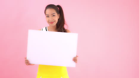 Template,-a-cute-female-cheerleader-holds-up-a-blank-post-board