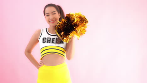 A-female-cheerleader-raises-and-shakes-a-single-gold-and-brown-pom-pom