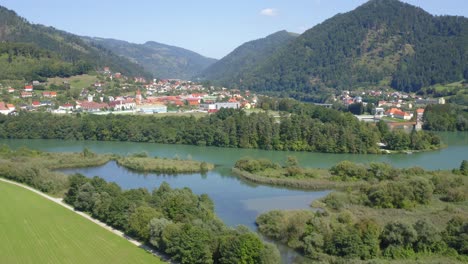 Lush-vegetation-surrounding-Lake-Dravograd-and-rolling-mountains