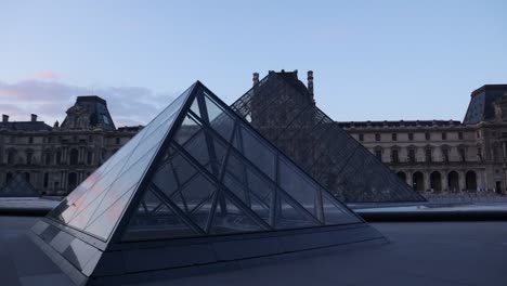 Parallax-of-the-Louvre-museum-pyramid-revealed-with-a-slow-arc-movement-on-gimbal,-early-mornign-wide-shot-with-nobody