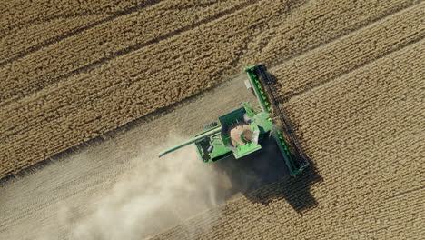 Top-View-Of-Harvesting-Combine-Working-On-Field-In-Saskatchewan,-Canada