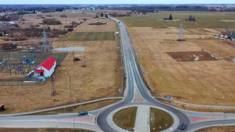 Cars-Driving-In-The-Road-With-Roundabout-Near-Pasvalys-Town-In-Panevezys-County,-Lithuania